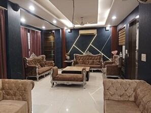 A modern living room with a sofa set, a coffee table, and a TV.