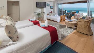 Family Room, Beach View, Sea Facing | Minibar, in-room safe, laptop workspace, blackout drapes