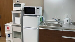 A compact kitchenette with a microwave, a small refrigerator, a sink, and a coffee maker. - YU'S HOUSE 2, a newly built property right next to JR Kamata Station (ootaku)