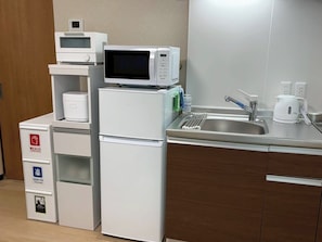 A compact kitchenette with a microwave, a small refrigerator, a sink, and a coffee maker. - YU'S HOUSE 2, a newly built property right next to JR Kamata Station (ootaku)
