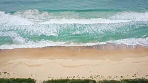 A beach with waves approaching the shore. - Sandy Shores, Serenity Resort (Diamond Beach)
