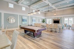 A spacious room with a pool table, comfortable seating, and a television. - Beautiful sunsets from 3rd Floor condo #934 (Palm Coast)
