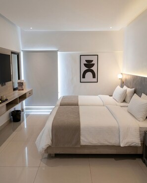A modern bedroom with a large bed, a bedside table, a wall-mounted TV, and a framed artwork. - Hamsun Clifton Apartment 3 Bedroom (Karachi)