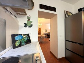 A kitchen with a stainless steel refrigerator, a sink, and a wall-mounted towel rack. - Beautiful apartment for 6 guests with A/C, WIFI and panoramic view (Cortona)