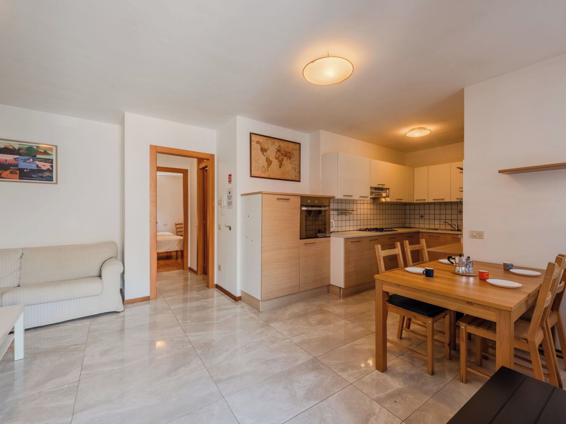 A modern apartment with a living room, kitchenette, and dining area.