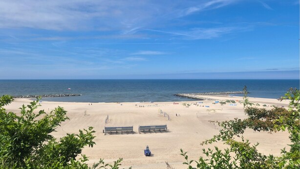 A beach with a clear sky, calm sea, and a few people. - 2 bedroom lovely home in Jezierzany (Jezierzany)