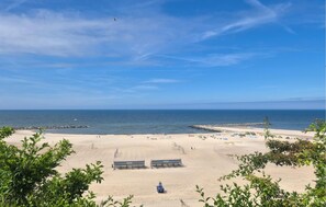 A beach with a clear sky, calm sea, and a few people. - 2 bedroom lovely home in Jezierzany (Jezierzany)