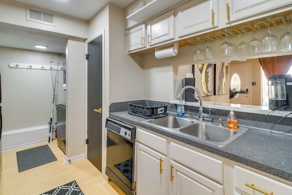A kitchen with a dishwasher, double sink, and a countertop with a dish rack and a bottle of dish soap. - Unit w/ Patio & Resort Perks! Walk to Lake Conroe (Montgomery)