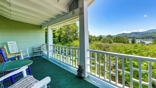 A covered porch with outdoor seating, a view of a lake and mountains, and a 'NO PARKING' sign. - Balcony w/ Stunning View! Lake Junaluska Retreat (Lake Junaluska)