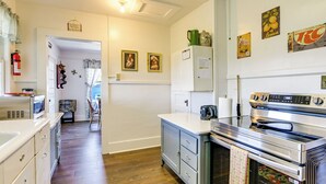 A kitchen with a stainless steel oven, white cabinets, and a wooden floor. - Balcony w/ Stunning View! Lake Junaluska Retreat (Lake Junaluska)