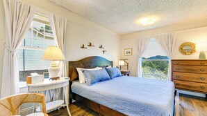 A bedroom with a wooden bed, a round mirror, a dresser, and a window with curtains. - Balcony w/ Stunning View! Lake Junaluska Retreat (Lake Junaluska)
