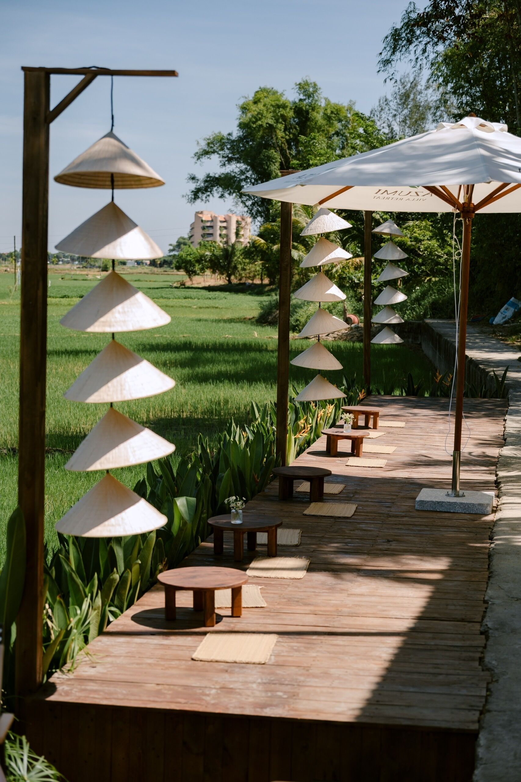 A wooden deck with outdoor seating and hanging conical shade structures.