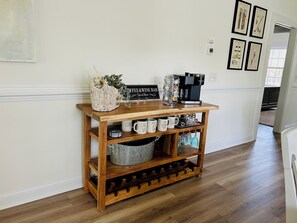 A wooden coffee station with mugs, a coffee machine, and a sign that reads 'Coffee & Wine Bar.' - Turtle Watch : 3  BR, 2  BA Condominium in Garden City, Sleeps 6 (Garden City)