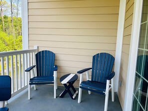 A porch with two Adirondack chairs and a small table. - Turtle Watch : 3  BR, 2  BA Condominium in Garden City, Sleeps 6 (Garden City)