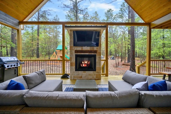 Gather around the outdoor fireplace as the sun sets and enjoy one of the cabin's most popular spaces for relaxing together.
