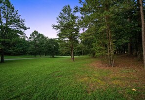 A grassy park area with trees and a clear sky. - ~2 Acres | Hot Tub | Fire Pit | Near Beavers Bend (Broken Bow)