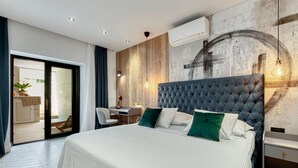 A modern bedroom with a large bed, a desk, and a chair, a sliding glass door to a balcony, and a wall-mounted air conditioner. - Apartment With Pool and hot tub (Konavle)