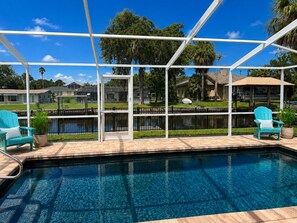 A pool area with a clear view of the surrounding landscape, including houses and trees. - Crystal River waterfront oasis w/floating dock 3BR/3BA house, large heated pool (Crystal River)