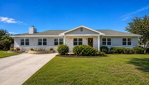 A single-story house with a stone facade, a front porch, and a well-maintained lawn. - Crystal River waterfront oasis w/floating dock 3BR/3BA house, large heated pool (Crystal River)