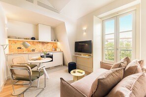 A modern apartment with a kitchenette, dining area, and a living room with a large window. - Armada III - One Bedroom Apartment, Sleeps 3 (Lisbon)
