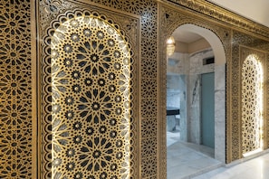 Un interior ornamentado con intrincados patrones geométricos y un suelo de mármol.