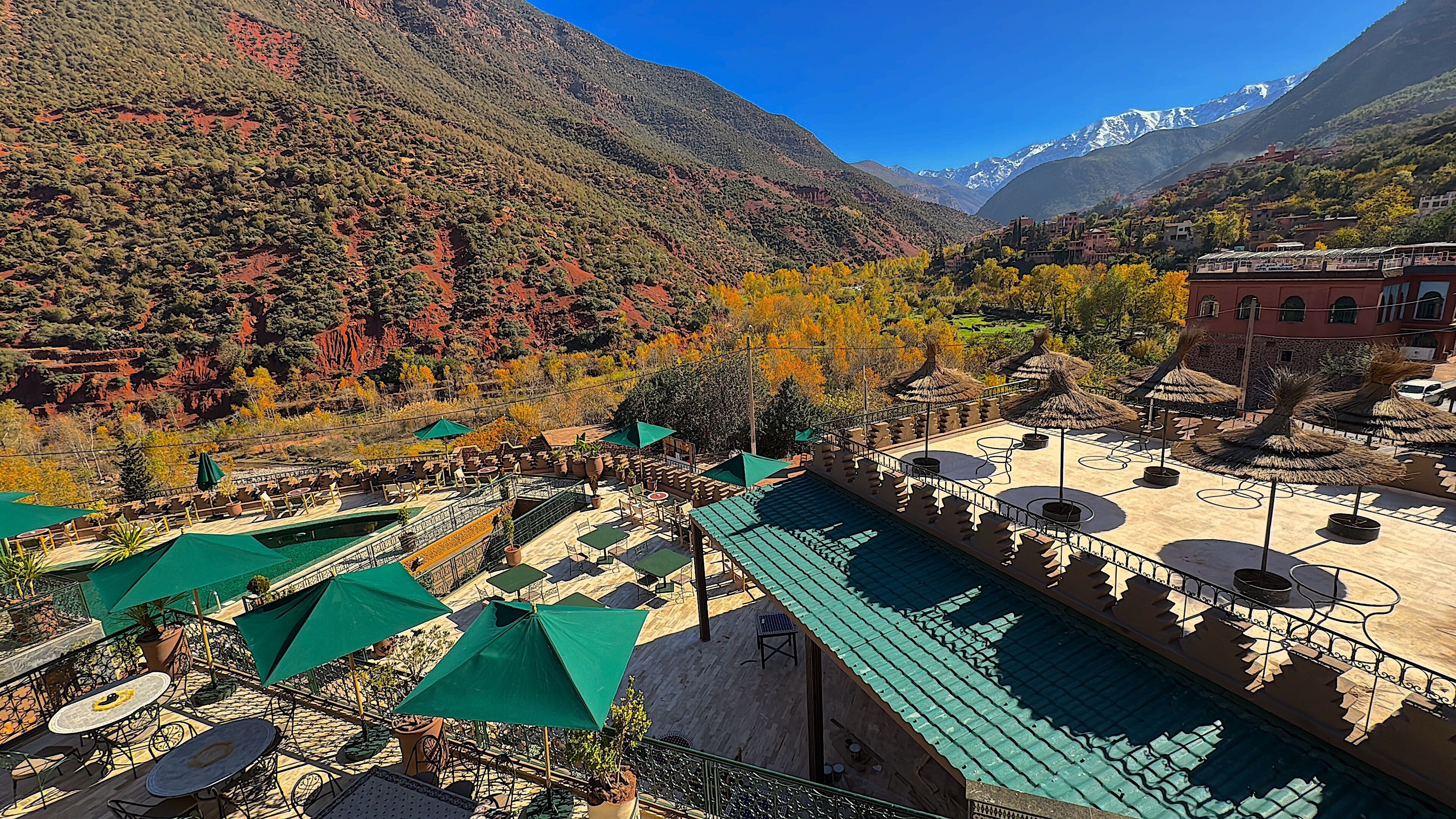 A terrace with outdoor seating, a pool, and mountain views.