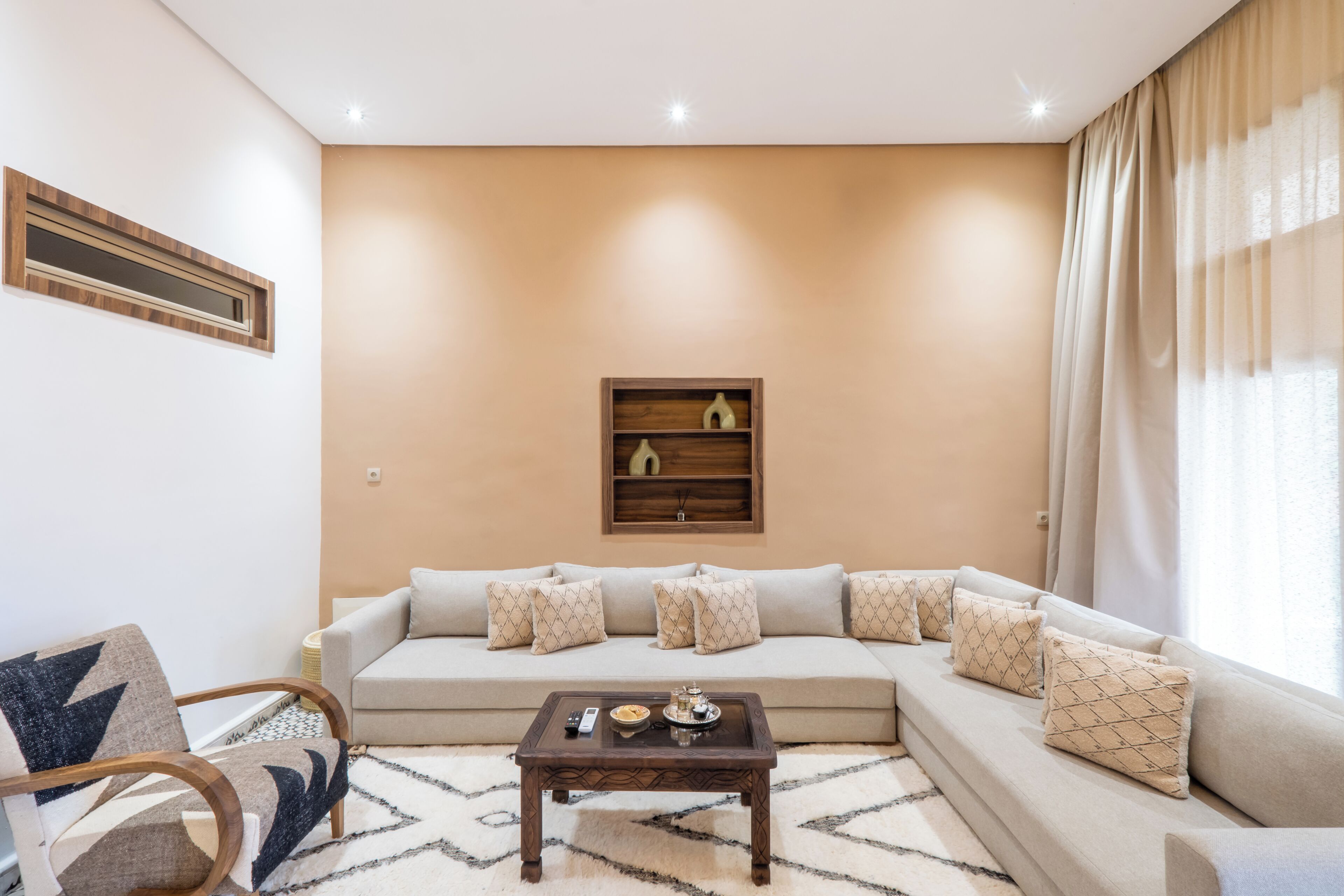 A living room with a sofa, a coffee table, and a chair.
