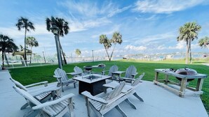 Outdoor seating with Adirondack chairs, a square table, and a grill. - Sabine 1E Couples Getaway Freshly Remodeled- Brand New Everything! (Pensacola Beach)