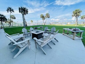 Outdoor seating with Adirondack chairs, a square table, and a grill. - Sabine 1E Couples Getaway Freshly Remodeled- Brand New Everything! (Pensacola Beach)