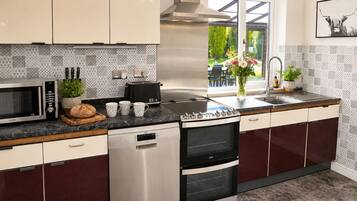 A modern kitchen with stainless steel appliances, a dishwasher, and a double oven.