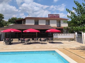 Seasonal outdoor pool, open 11:00 AM to 7:00 PM, pool umbrellas