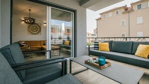 A modern living room with a sofa, chairs, a coffee table, and a dining table. - Spacious Luxury Trogir Apartments - Comfort Two Bedroom Apartment (Trogir)