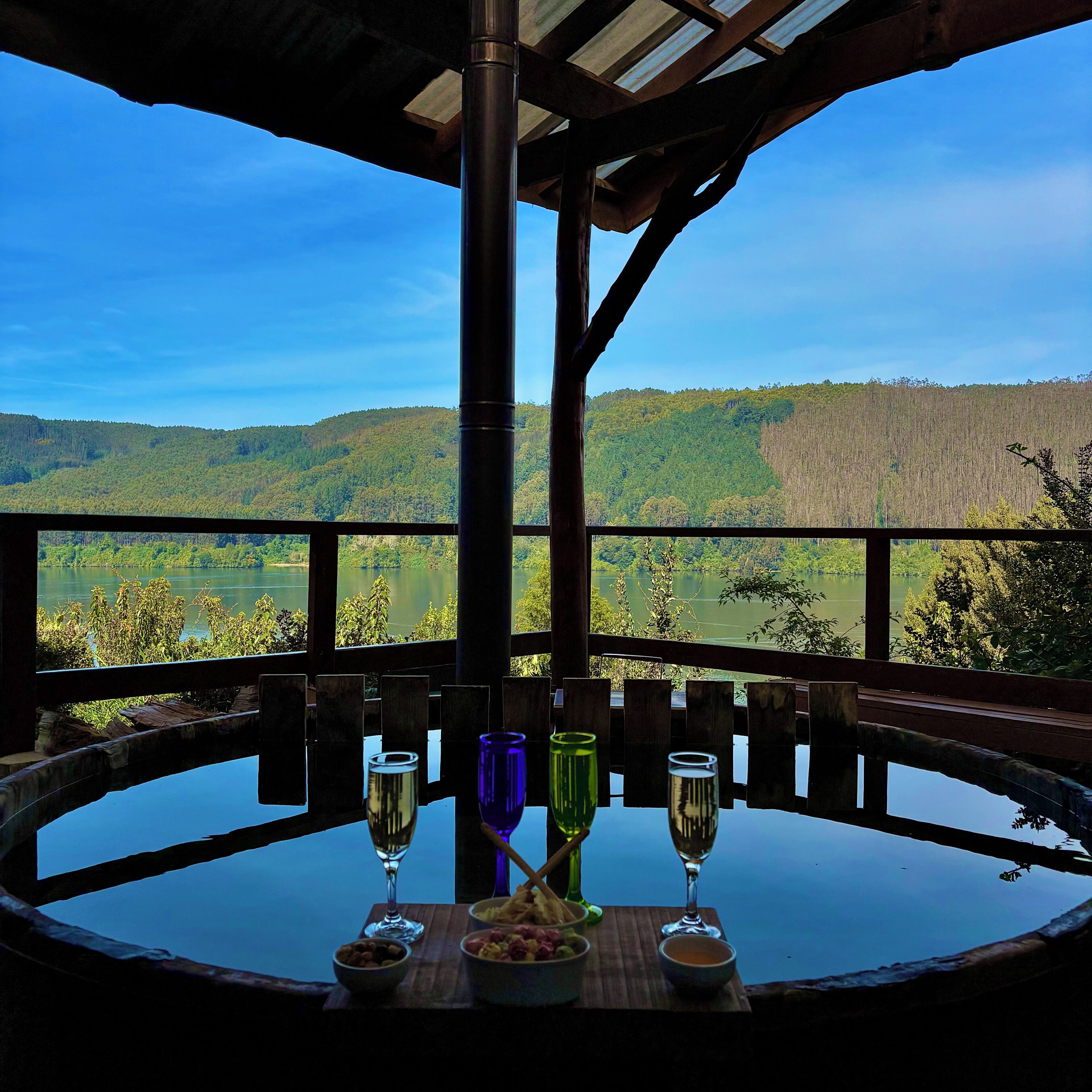 A table with a view of a lake and forest.