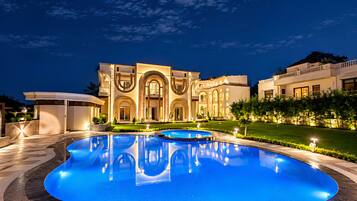 A large, modern building with a pool in front.