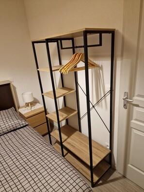 A bedroom with a bed, a nightstand, a dresser, and a wardrobe with shelves. - Stunning 2-room apartment for 6 people at the foot of the Chabanon slopes (Selonnet)