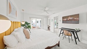 A bedroom with a bed, a desk, and a chair. - Private House - Pool, Firepit, Dog Friendly, Walk to Beach, FREE EV Charger (Cocoa Beach)
