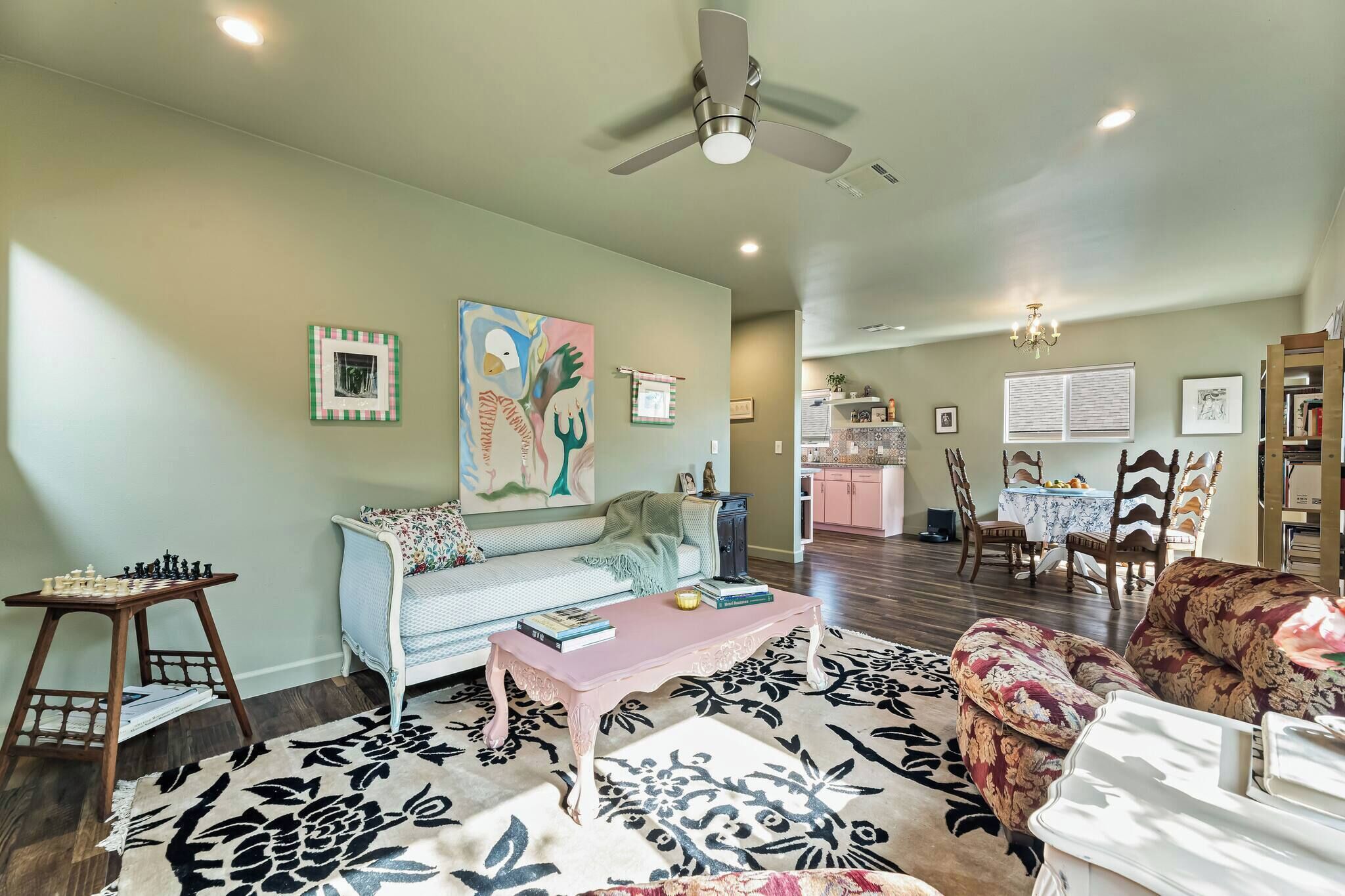 A living room with a sofa, coffee table, and a chessboard.