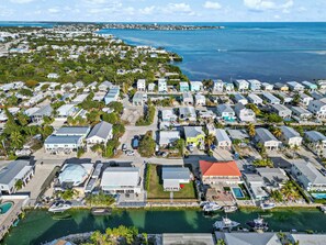 A coastal residential area with houses, a marina, and a clear view of the ocean. - The Perfect Hideaway Retreat for Your FLKeys Getaway (Marathon)