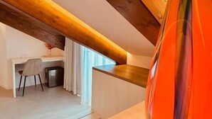A modern interior with a wooden ceiling, a desk, and a colorful vase.