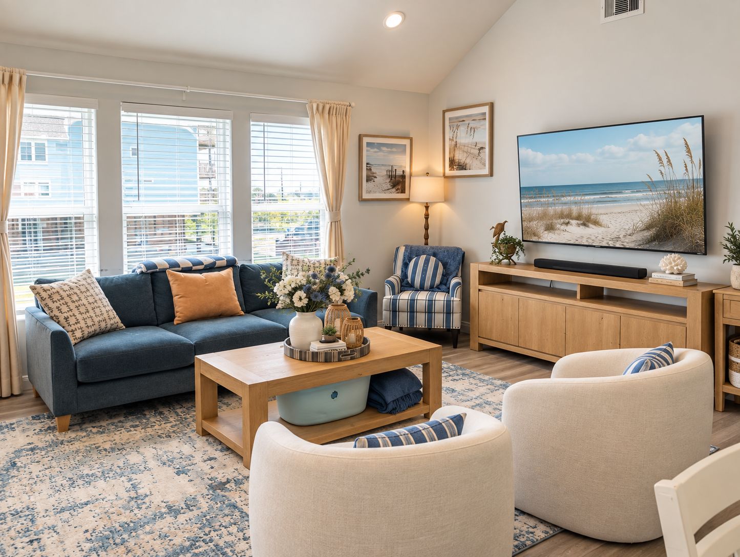 A living room with a sofa, armchairs, a coffee table, and a television.
