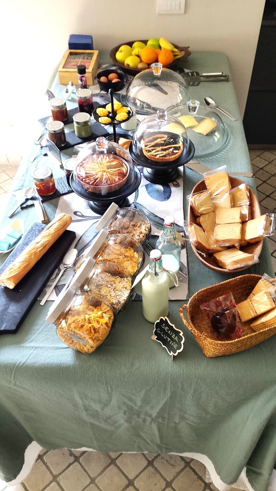 A table with various food items, including bread, cheese, and fruits.