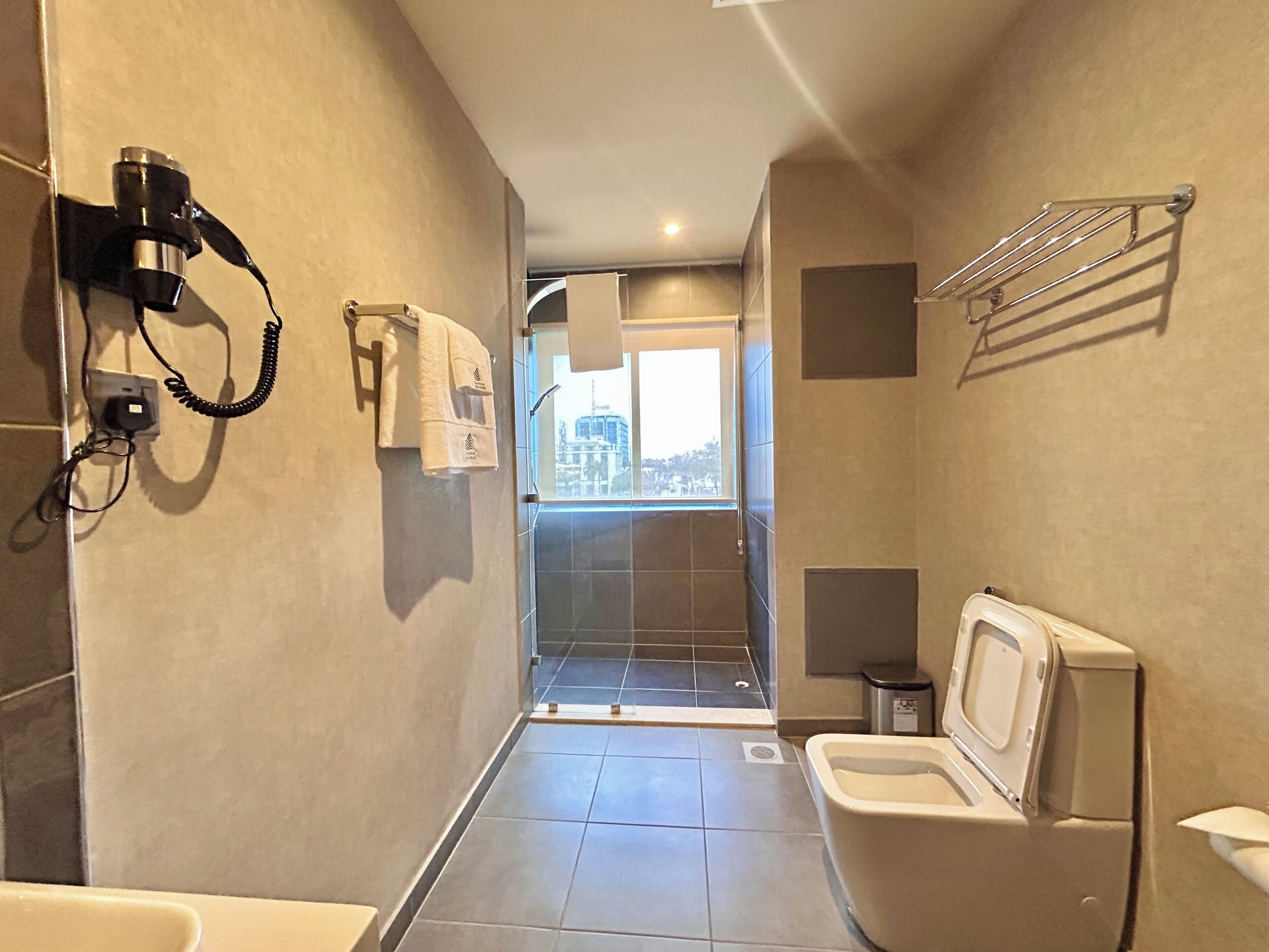 Deluxe kamer | Badkamer | Een haardroger, pantoffels, handdoeken, zeep