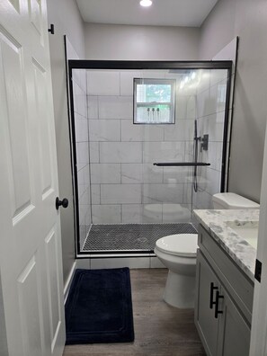 A bathroom with a shower, toilet, and sink. - South Downtown and Southside Beltline (Atlanta)
