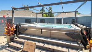 A hot tub with steps and a pergola structure. - Amazing new home- All the Amenities! (Murphys)