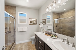 A modern bathroom with a glass shower enclosure, dual sinks, and a large mirror. - Amazing new home- All the Amenities! (Murphys)