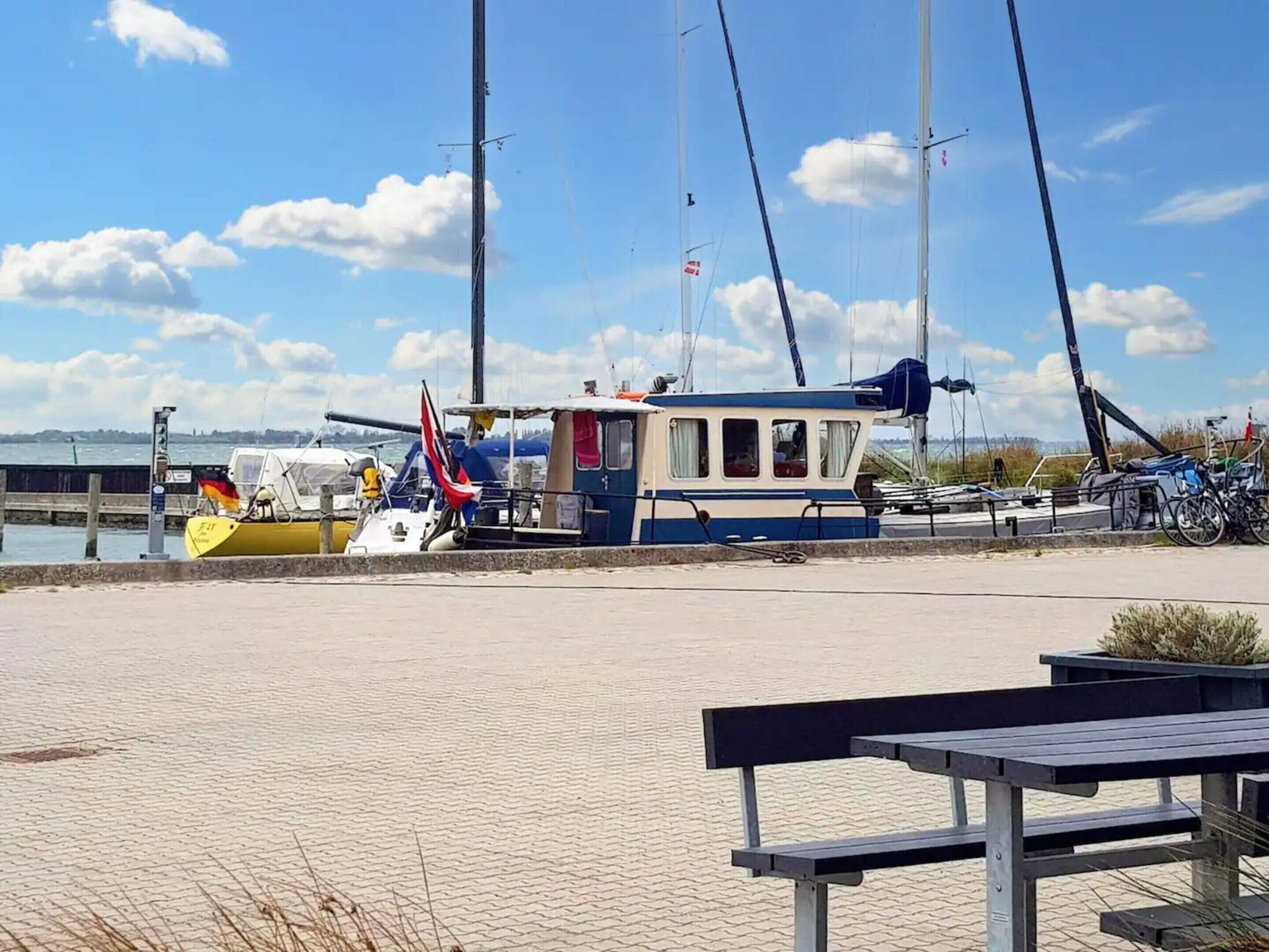 A marina with boats, a dock, and a bench.