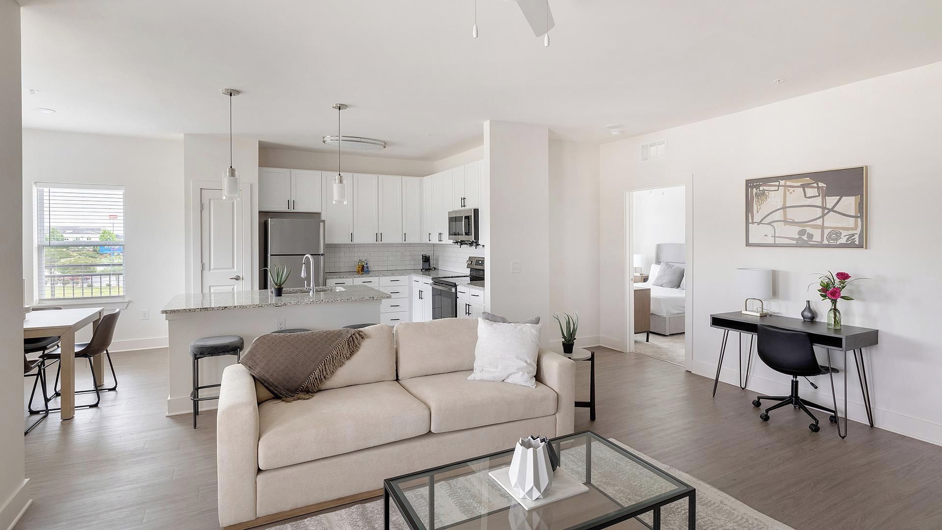 Un appartement moderne comprenant un salon, une cuisine, un coin repas et une chambre.