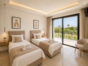 A hotel room with two beds, a large window with a view, and a chair. - Palm Oasis Estate Dar Bouazza – 2 Private Villas • 16 Guests • 25m Swimming Pool (Tamaris)
