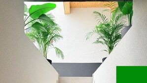 A staircase with a plain wall on either side and a green rectangular object on the right.
