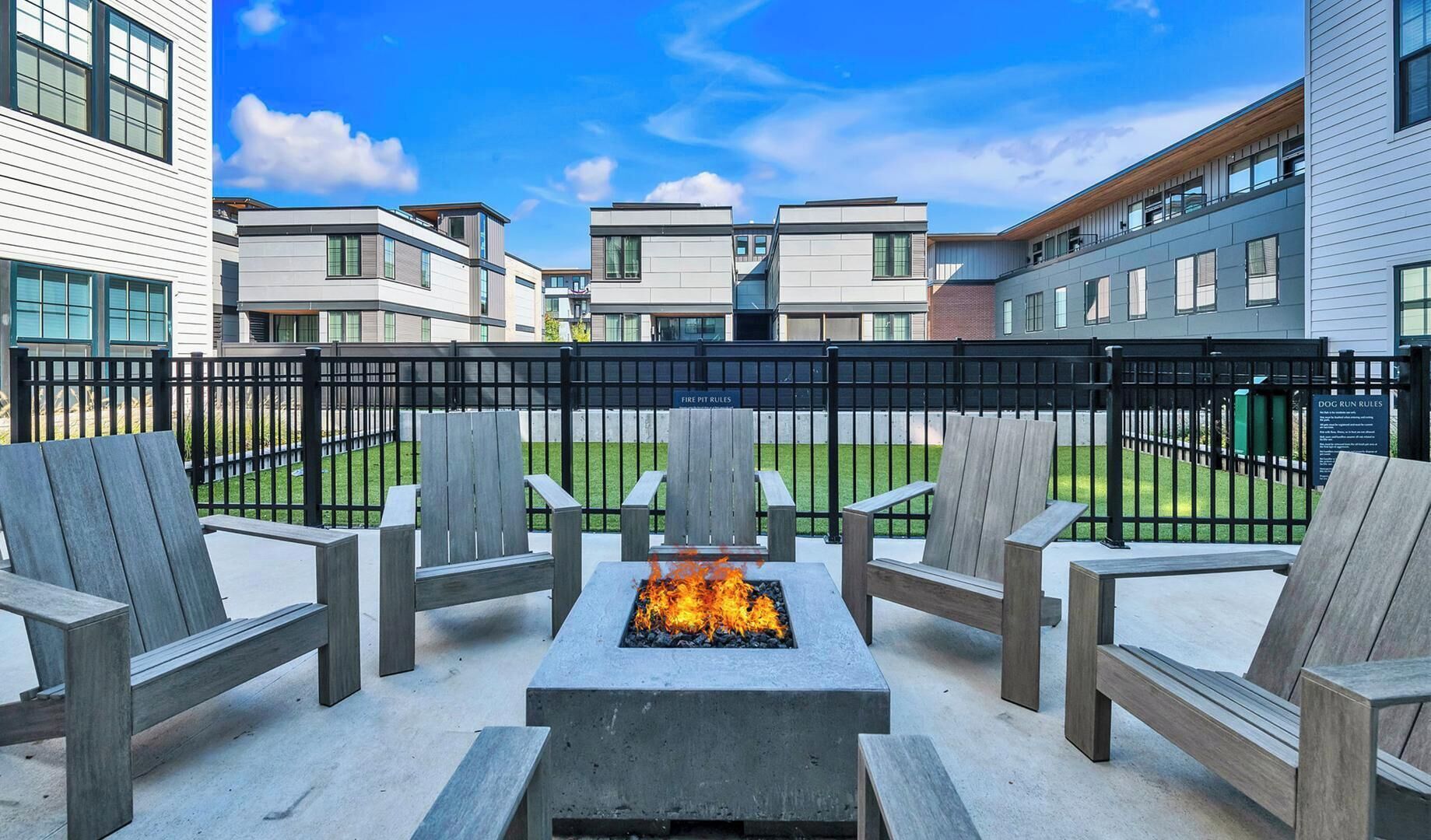 A patio area with outdoor seating and a fire pit.